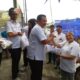 Ketua DPC Perindo Sunggal Bornok Simanjuntak saat membagikan beras kepada kader. (Waspada/Edward Limbong).