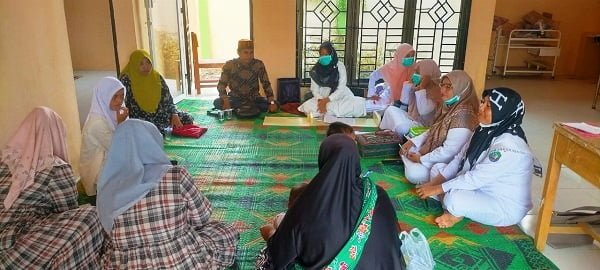Kades Ladang Tuha II, Kecamatan Lembah Sabil, Abdya, Mukhlis SHi, saat memfasilitasi para warga, dengan tenaga medis yang bertugas di Poskesdes Ladang Tuha II. Kamis (13/10). Waspada/Syafrizal