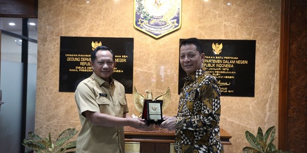 Pj.Gubernur Aceh Achmad Marzuki menerima plakat dari Mendagri Muhammad Tito Karnavian, saat melakukan pertemuan di Jakarta, belum lama ini. Waspada/Ist