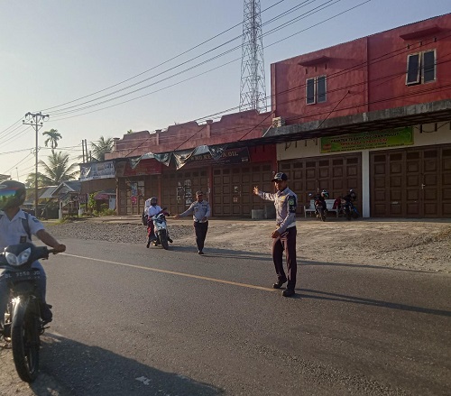 URAI KEMACETAN - Petugas Dinas Perhubungan Aceh Besar mengatur jalan agar tidak terjadi kemacetan di kawasan Pasar Lambaro, Kecamatan Ingin Jaya, Selasa (7/3). (Waspada/Ist)