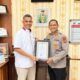 Kapolres Lhokseumawe, AKBP Henki Ismanto S,ik menyerahkan penghargaan kepada Rektor Universitas Malikussaleh (Unimal) Prof. Dr. Herman Fithra, S.T., M.T., IPM, Kamis (13/4). Waspada/Zainuddin. Abdullah