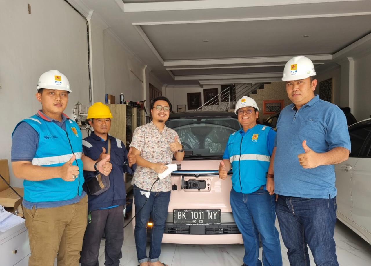 Manager ULP Medan Timur (kanan), Petugas PLN dan pengguna kendaraan listrik (tengah), foto bersama usai serah terima pemasangan home charging.