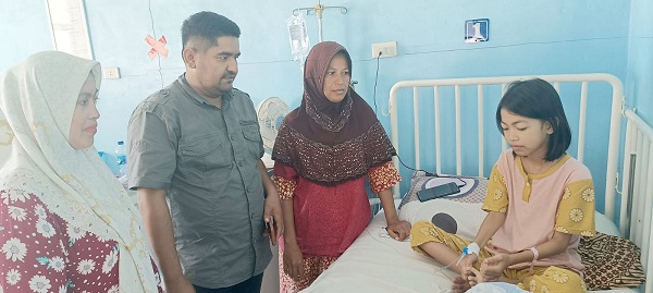 Tri Wulan Dini, 10,5 tahun, bocah perempuan bocor jantung asal Gampong Lampoih Krueng, Kecamatan Kota Sigli, Kabupaten Pidie terlihat duduk di atas ranjang di ruang rawat inap RSUD Tgk Chik Ditiro Sigli, saat dibesuk Ketua KP2A M.R Yani Z, Rabu (21/6). Waspada/Muhammad Riza