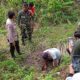 Personel Polsek dibantu warga saat mengeruk tanah tempat ditanamnya jasad sang bayi, di kebun sawit milik warga Nagori Buntu Turunan, Jumat (23/6).(Waspada/ist).