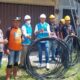 Petugas PLN saat melakukan pemutusan aliran listrik dan menggulung kabel penghantar listrik yang digunakan untuk menyalurkan Tenga Listrik Secara Tidak Sah, di salah satu lokasi yang diduga dijadikan tempat penambangan bitcoin.