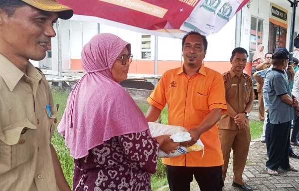 Kepala Kantor Pos Singkil Maimun didampingi Kepala Dinas Tanaman Pangan Aceh Singkil, Abdul Haris saat menyerahkan bantuan beras CBP kepada keluarga penerima manfaat secara simbolis. WASPADA/Ariefh