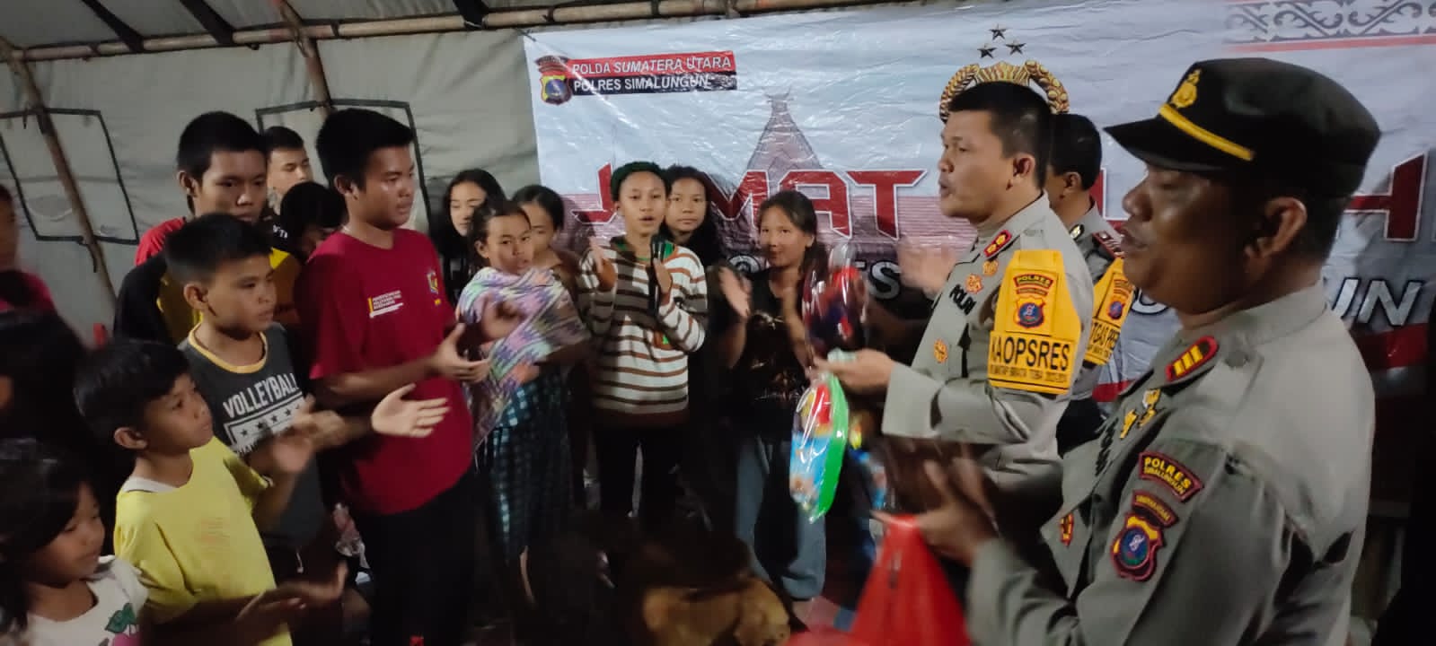 Kapolres Simalungun, AKBP Ronald FC Sipayung, saat menyerahkan bantuan kepada korban banjir, Sabtu (23/12) malam.(Waspada/ist)