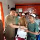 Kadis Sosial Palas, H Achmad Fauzan Nasution menyerahkan bantuan sosial Kemensos RI kepada anak yatim atau piatu di Kantor Pos Sibuhuan, Senin (18/12). Waspada/Muhammad Satio)