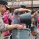 Kapolres AKBP Yogen Heroes Baruno (kiri) hendak menyiramkan air bunga kepada salah seorang personel dari 55 personel Polres Pematangsiantar yang mendapat kenaikan pangkat setingkat periode 1 Januari 2024 di lapangan apel Mapolres, Jl. Jend. Sudirman, Rabu (3/1).(Waspada-Ist).
