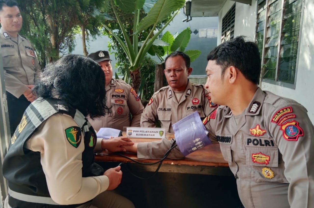 Sie Dokkes Polres Pematangsiantar memberikan pelayanan kesehatan kepada personel yang bertugas di sekretariat PPK di sela penghitungan suara hasil Pemilu 2024 di sekretariat PPK, Rabu (21/2).(Waspada-Ist).