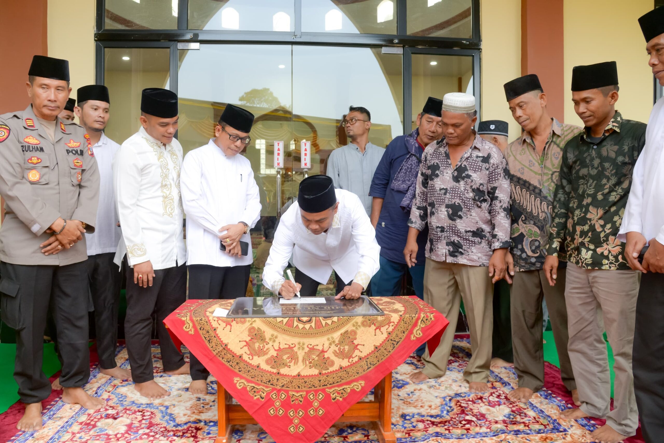 Bupati Sergai H Darma Wijaya disaksikan Kakan Kemenag Sergai H Zulkifli Sitorus, Kasi Intel Kejari Sergai Romel Tarigan, Kades Bajaronggi Rifai, Ketua BKM Nurul Iman, Paimin, Muspika Dolok Masihul saat menandatangani prasasti masjid Nurul Iman yang baru diresmikan, Senin (18/3) kemarin di Dusun VII Desa Bajaronggi Kec.Dolok Masihul.(Waspada/Edi Saputra)