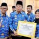 Bupati Simalungun, Radiapoh Hasiholan Sinaga, disaksikan Wabup H.Zonny Waldi, saat menyerahkan piagam kepada Kadis Sosial, Osnidar Marpaung, di acara Rakorpem di Balei Harungguan Djabanten Damanik, Kantor Bupati Simalungun di Pamatangraya, Senin (18/3).(Waspada/Ist).