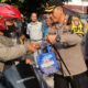 Kapolres Pematangsiantar AKBP Yogen Heroes Baruno (kanan) menyerahkan takjil kepada pengendara sepeda motor yang tertib berlalulintas dalam Operasi Keselamatan Toba 2024 menjelang berbuka puasa di Jl. Sutomo, depan KDH Kapolres, Senin (18/3).(Waspada-Ist).
