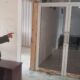 Seorang anggota Polisi Syariah (Wilayatul Hisbah) Lhokseumawe memperlihatkan kerusakan pintu yang dirusak oknum Satpol PP, Kamis (4/4). Waspada/Zainal Abidin