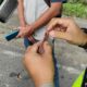 Personel Lantas Polres Asahan memeriksa SIM Palsu yang menggunakan stiker terjaring dalam razia terpadu di Jalinsum, Kisaran. Waspada/Bustami CP