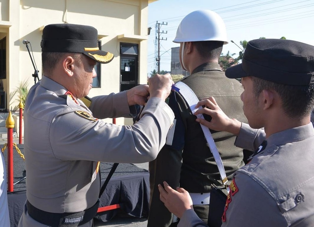 Kapolres Langsa, AKBP Andy Rahmansyah, S.I.K., S.H., M.H menyematkan pita kepada perwakilan personel Operasi Patuh Seulawah 2024 bertemakan 'Tertib Berlalu Lintas Demi Terwujudnya Indonesia Emas' di lapangan hitam Mapolres Langsa, Senin (15/7). Waspada/dede
