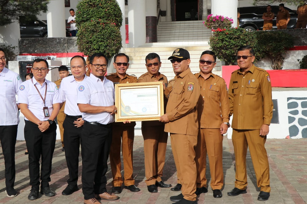 Bupati Toba, Poltak Sitorus menerima penghargaan berupa Predikat Universal Health Coverage (UHC) terkait Kepesertaan 98,76% Program Jaminan Kesehatan Nasional (JKN) dari BPJS Kesehatan, Senin (22/7). Waspada/Ist
