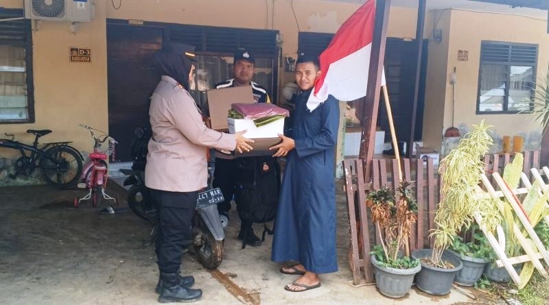 Kapolsek Jaya Baeu, Iptu Murni, saat menyerahkan bantuan masa panik kepada Bripka Said Jamal, yang menjadi salah satu korban kebakaran di Asrama Polisi Lamteumen II, Senin (5/8) malam. (Waspada/Zafrullah)