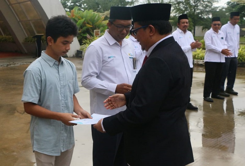 MANJEMEN IP menyerahkan piagam kepada salah seorang anak pegawai yang berprestasi. Waspada/Ist