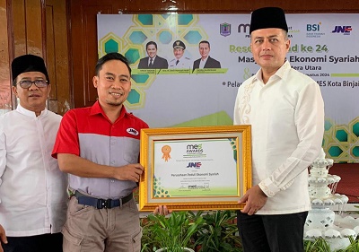 KETUA PW MES Sumut Musa Rajekshah memberikan penghargaan kepada JNE Medan diterima Fikri Alhaq Fachryana selaku Branch Manager JNE Medan pada acara Milad MES ke 24 di Pendopo Rumah Dinas Walikota Binjai. Waspada/ist