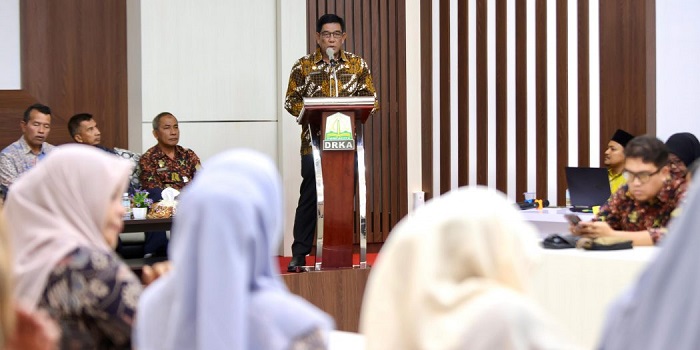 Plt. Sekda Aceh, Muhammad Diwarsyah, saat menyampaikan sambutan pada kegiatan Focus Group Discussion (FGD) Optimalisasi Data Kepesertaan Jaminan Kesehatan Aceh (JKA) di Aula Dinas Registrasi Kependudukan Aceh, Banda Aceh, Kamis (31/10). (Waspada/Zafrullah)